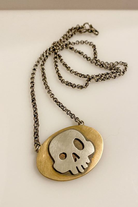 skull on brass necklace