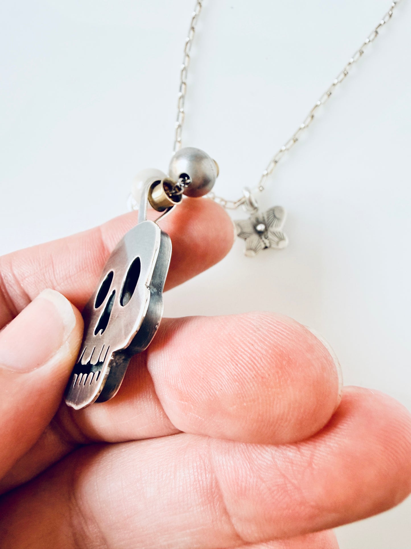 Sterling skull pendant with butterfly and beads