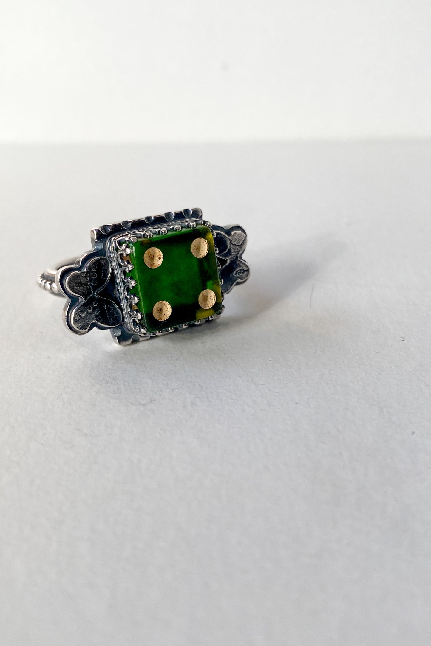 Green die and butterfly ring