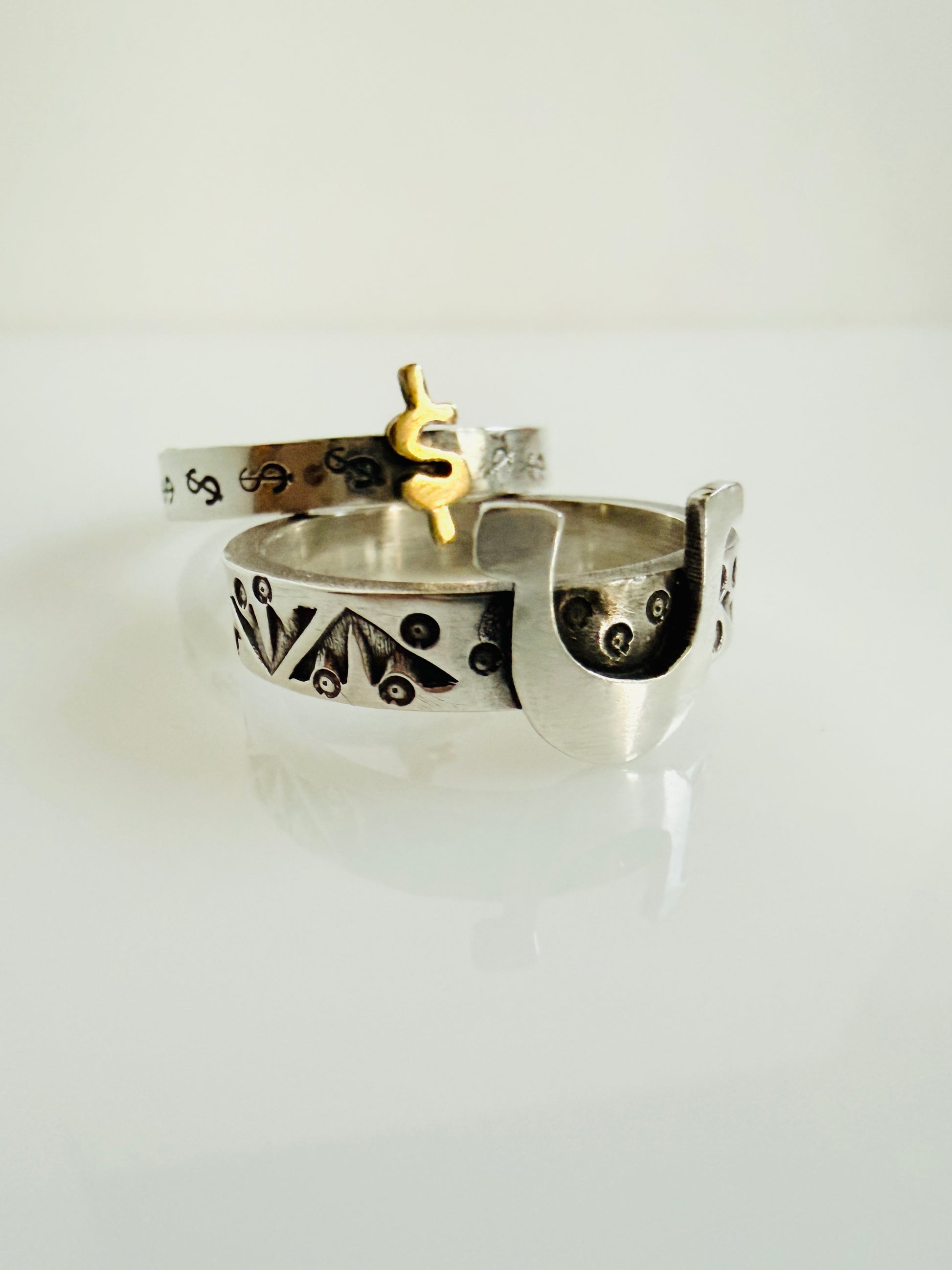 Sterling stacking rings with symbols of horseshoe and dollar sign 